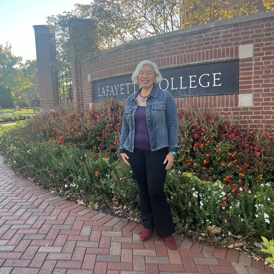 Dr. Tania Israel in front of a college